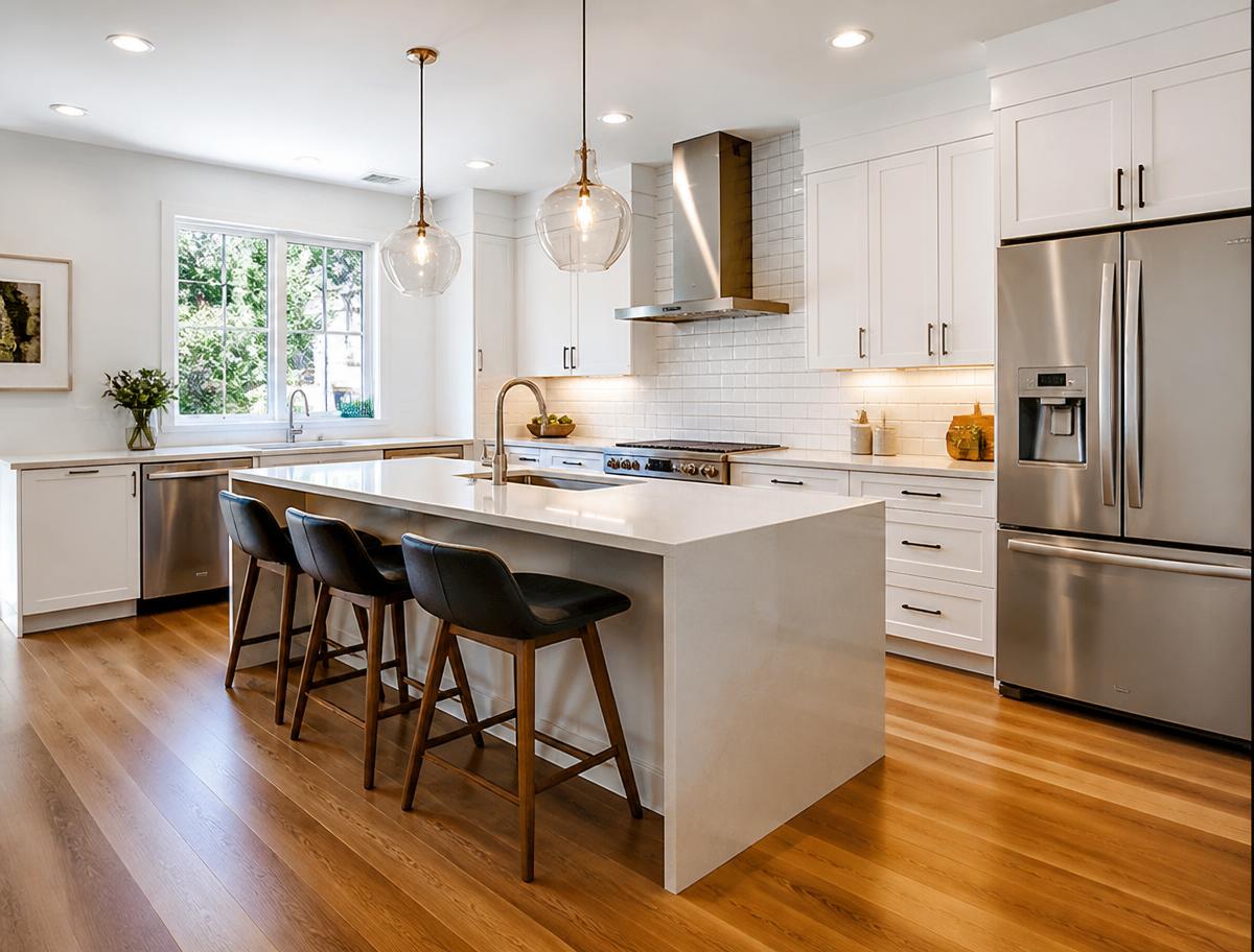 Finished kitchen remodel with white shaker cabinets and quartz island
